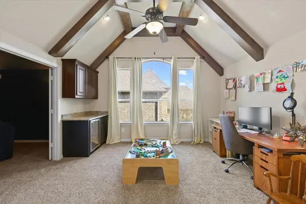 a living room with furniture and a kitchen view