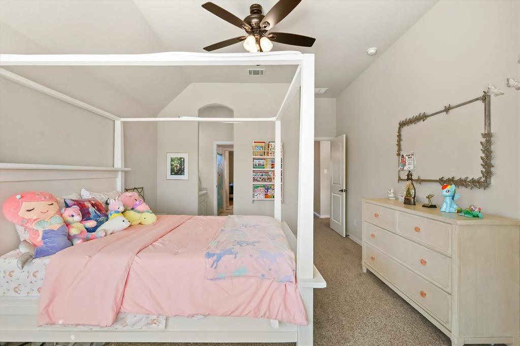 14006 Stars Road Frisco, TX 75035 - Photo 26 of 38 a bedroom with a bed and a chandelier fan