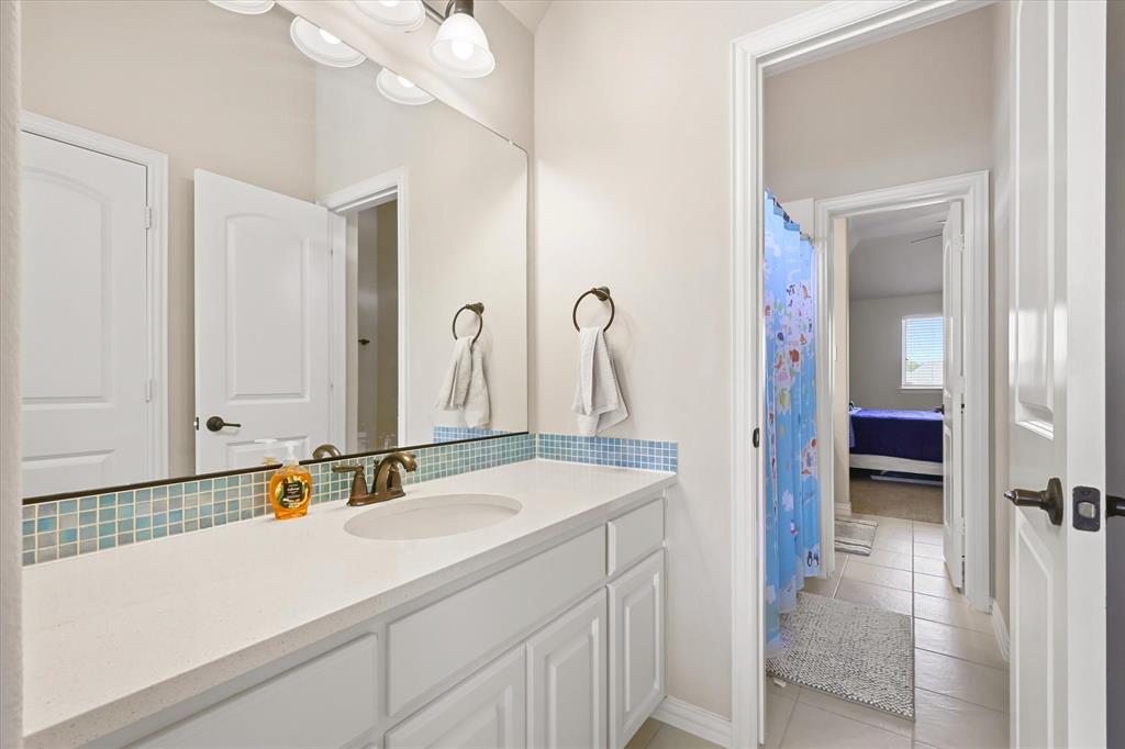 14006 Stars Road Frisco, TX 75035 - Photo 27 of 38 a bathroom with a sink and a mirror