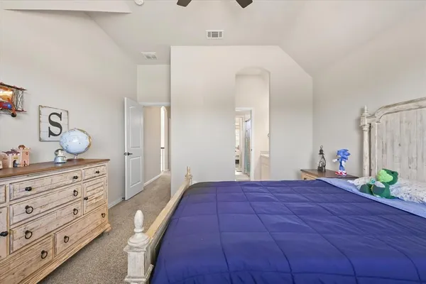 a bedroom with a bed and a dresser