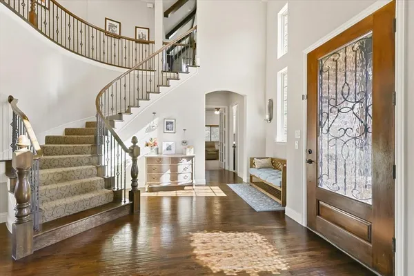 a view of entryway and hall with wooden floor