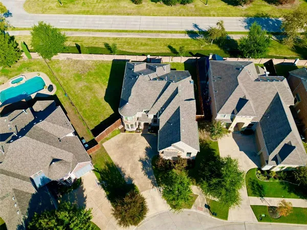 an aerial view of a house with swimming pool and patio