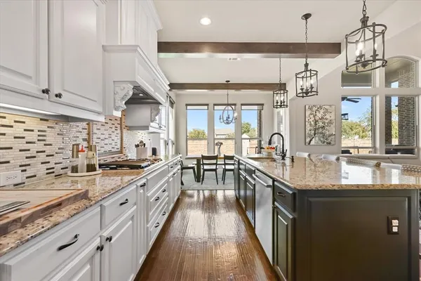 a kitchen with granite countertop lots of counter top space and stainless steel appliances