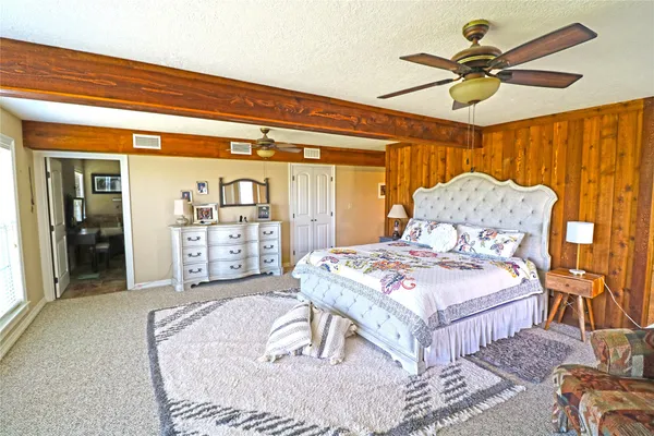 a living room with furniture a rug and a large window