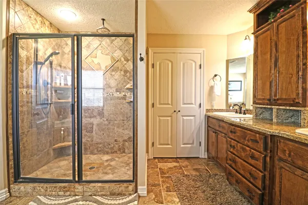 a bathroom with a double vanity sink and a mirror