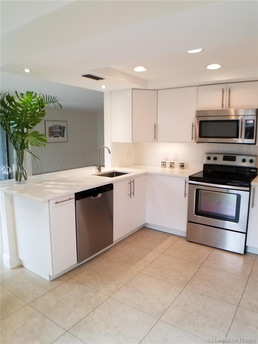 Sparkling white/quartz counter kitchen with stainless appliances