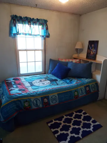 a living room with hard wood floor and a window