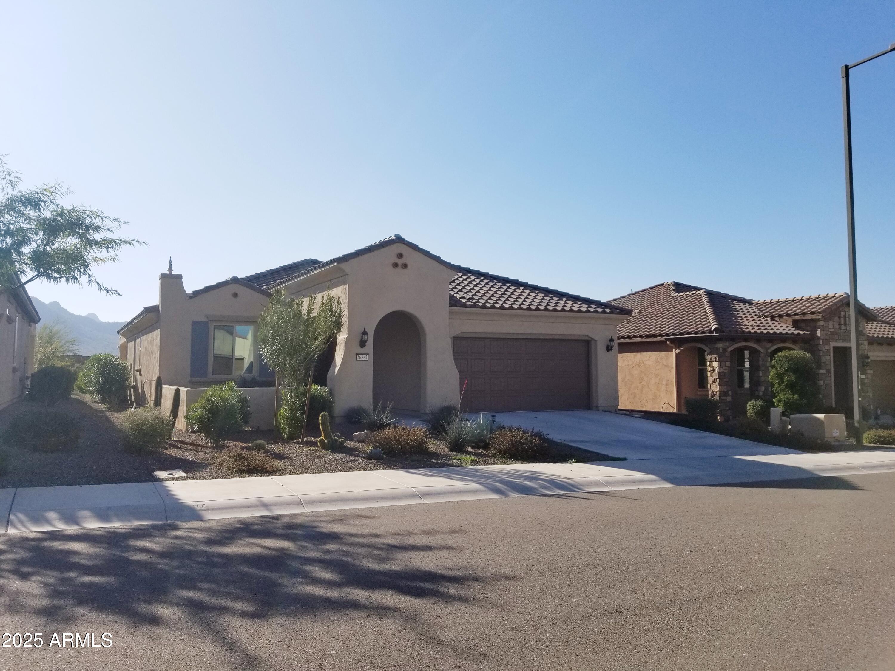 26881 West Utopia Road Buckeye, AZ 85396 - Photo 1 of 31 a front view of a house with a yard