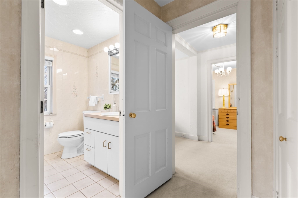 30 Pine Ridge Road Medford, MA 02155 - Photo 23 of 42 a bathroom with a toilet a sink and a large mirror
