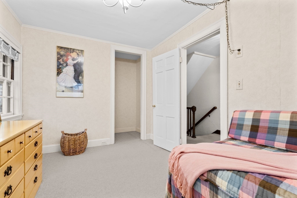 30 Pine Ridge Road Medford, MA 02155 - Photo 32 of 42 a bedroom with a bed and a painting on the wall