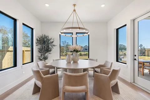 a kitchen with a table chairs sink and cabinets