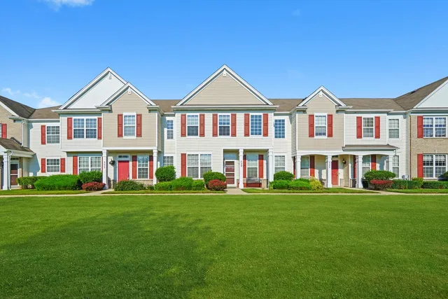a front view of building with yard and green space
