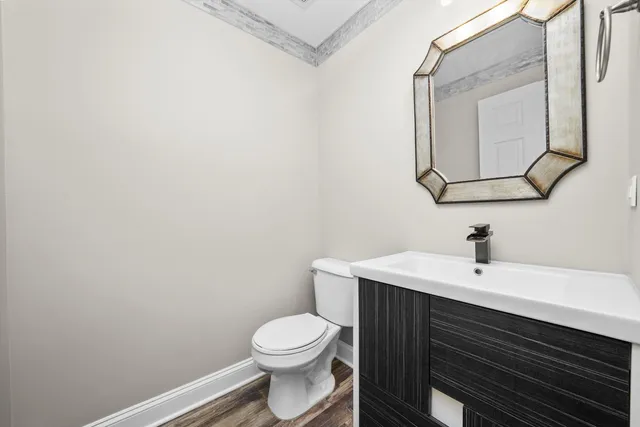 a bathroom with a toilet a sink and mirror