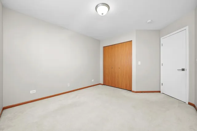 an empty room with closet area