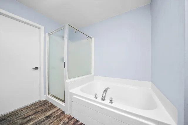 a bathroom with a tub and shower