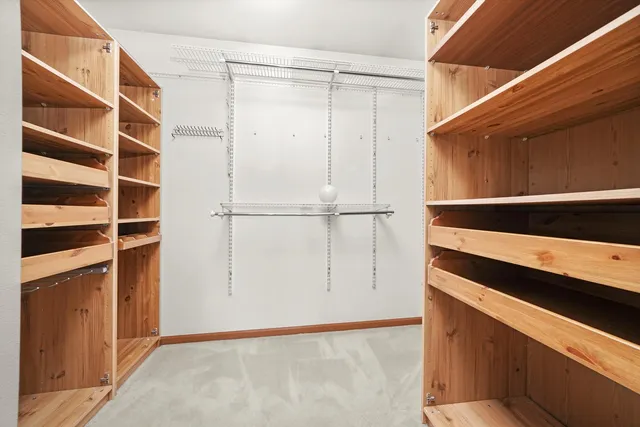 a view of walk in closet with empty racks