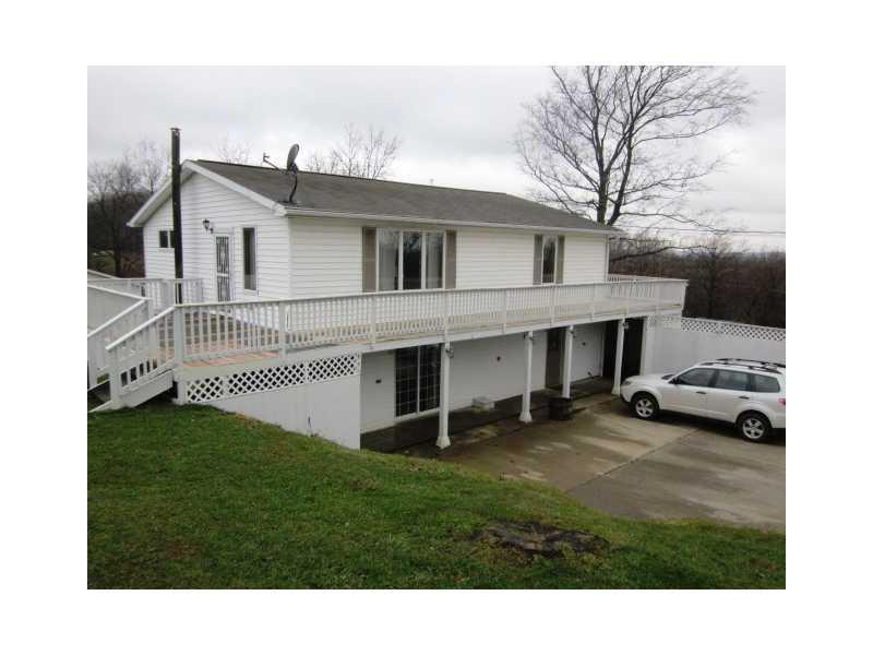 Exterior Front. OUTDOORABLE RAISED RANCH - 3 bedroom, 2 bath Country Casual home with lovely wrap-around deck nestled on 1.19 acre in Washington Township, Greene County.