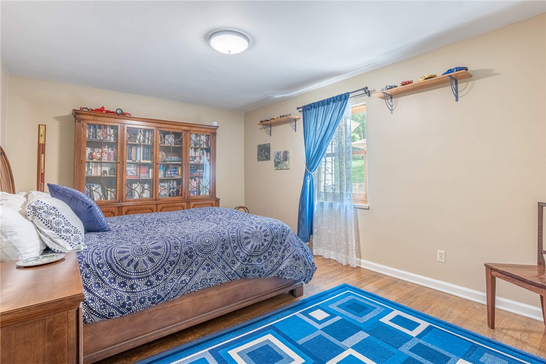 156 West Hadley Road Dayton, OH 45419 - Photo 23 of 71 This inviting bedroom features rich hardwood flooring and a bright window, creating a serene personal retreat.