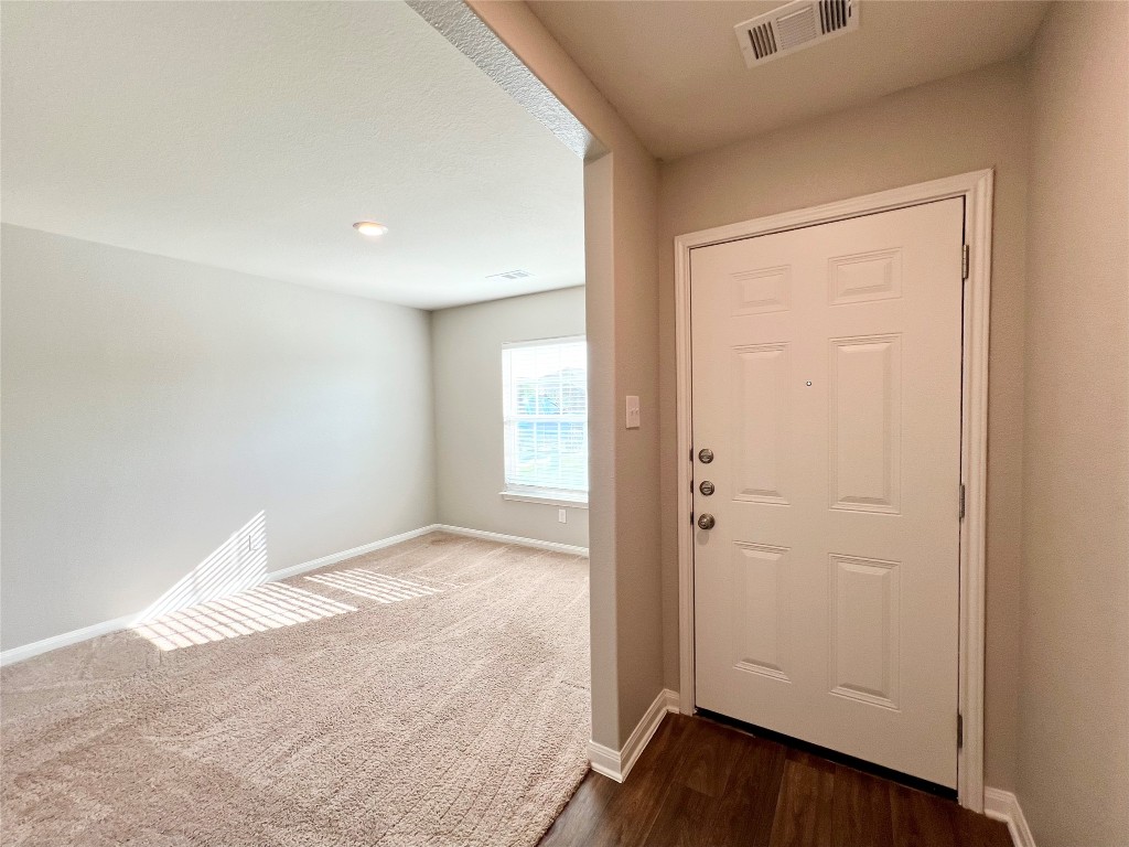 1033 Riverdale Cove Jarrell, TX 76537 - Photo 13 of 13 an empty room with wooden floor and closet