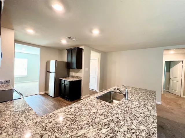 a large bedroom with a bed and a television in it