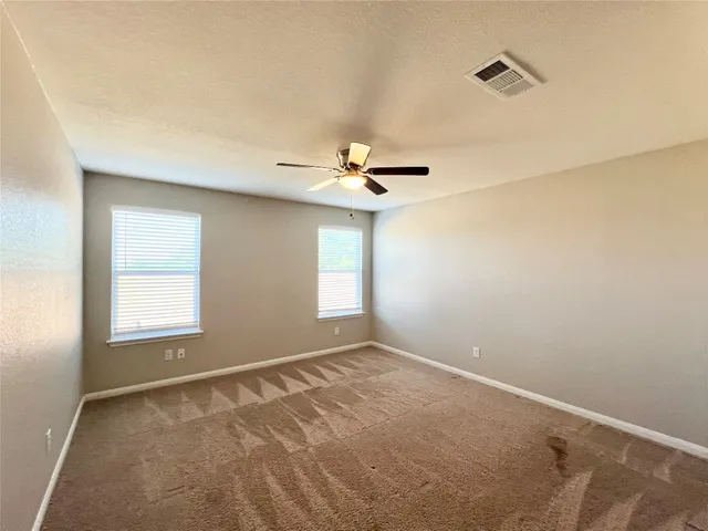 a view of a livingroom with a ceiling fan and window