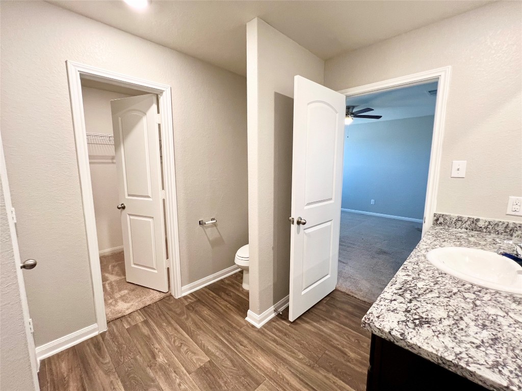1033 Riverdale Cove Jarrell, TX 76537 - Photo 10 of 13 a bathroom with a granite countertop sink and a mirror