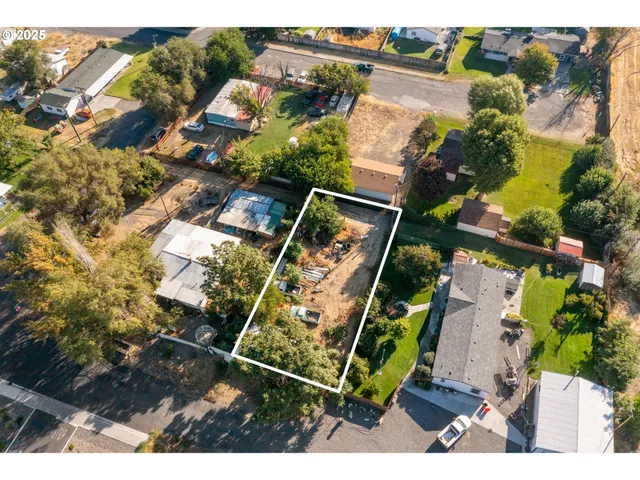 an aerial view of a house with a yard and plants