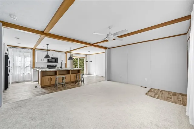 a kitchen with stainless steel appliances a refrigerator and microwave
