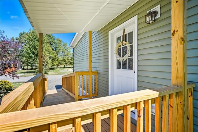 a view of a balcony with wooden floor and fence