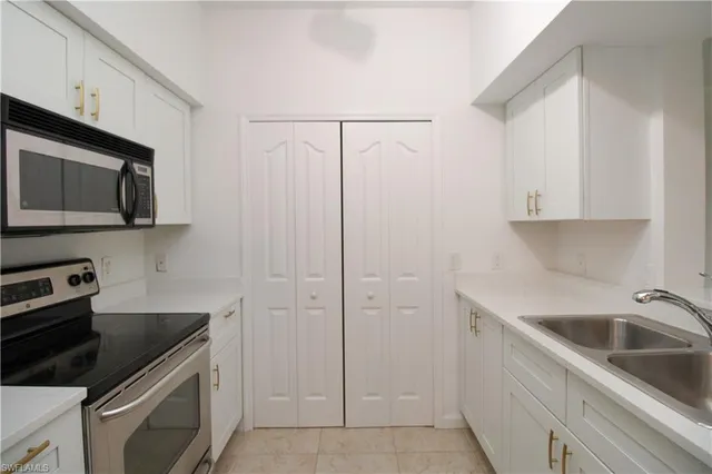 a kitchen with a sink stove and refrigerator