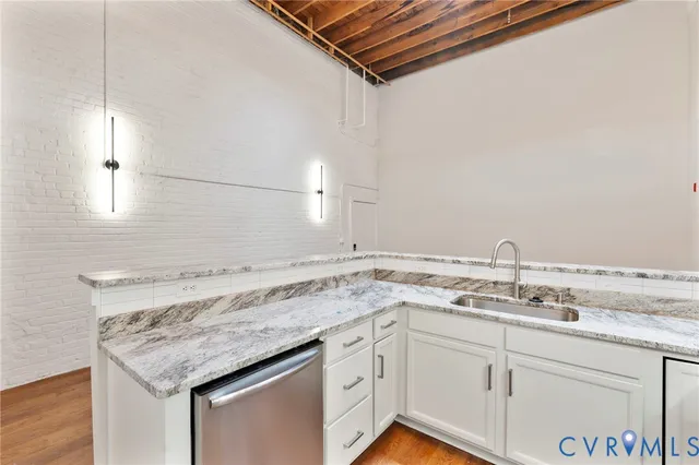 a utility room with a sink and dishwasher
