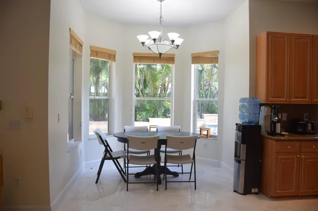 a view of a dining room with furniture and window