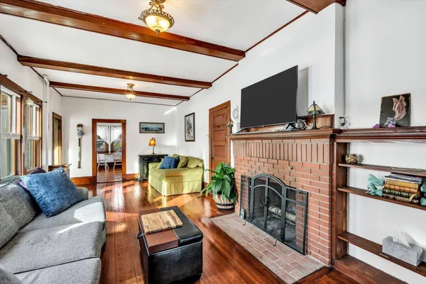 a living room with furniture a flat screen tv and a fireplace