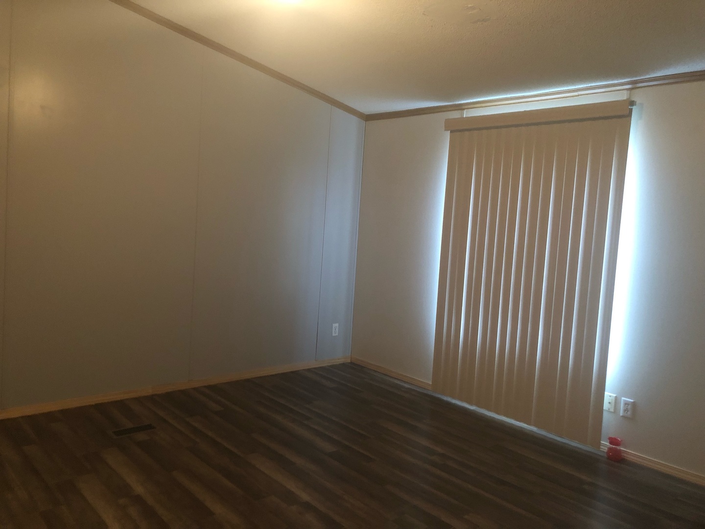 772 North 3906 Th Road Triumph, IL 61371 - Photo 5 of 14 an empty room with wooden floor and windows with curtains
