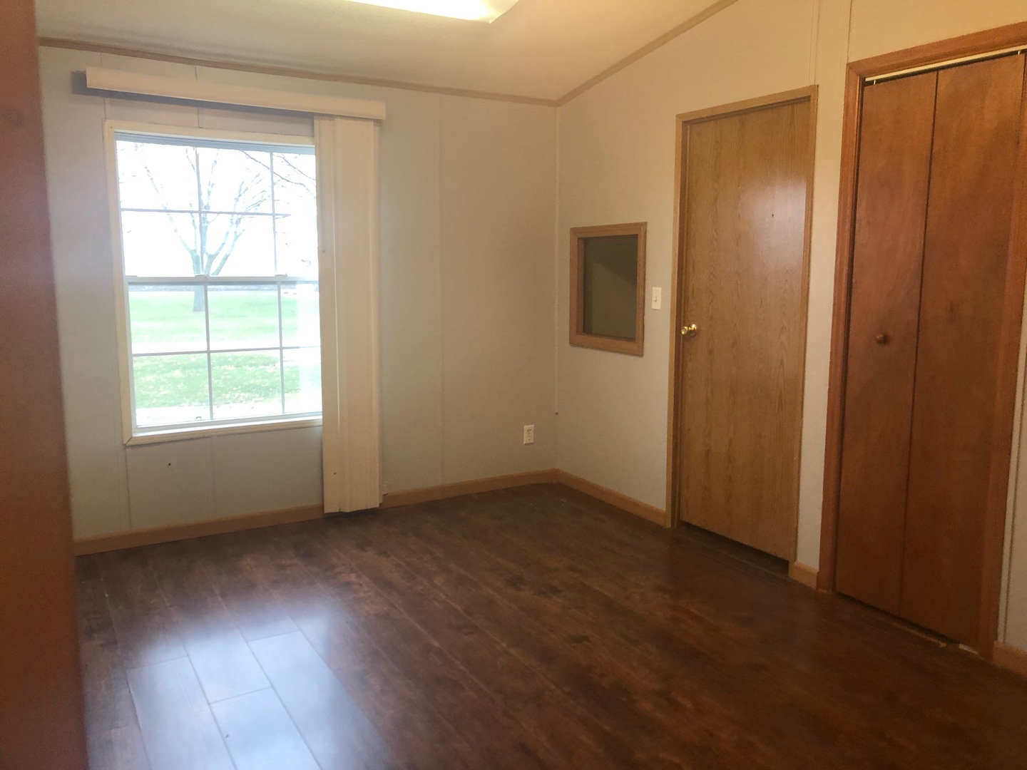 772 North 3906 Th Road Triumph, IL 61371 - Photo 10 of 14 a view of an empty room with wooden floor and a window