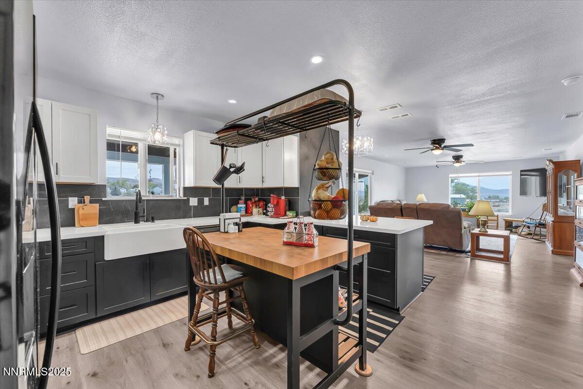 4895 Cheyenne Trail Stagecoach, NV 89429 - Photo 11 of 52 a dining hall with stainless steel appliances kitchen island a table and chairs in it