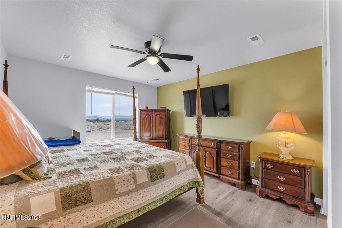 4895 Cheyenne Trail Stagecoach, NV 89429 - Photo 14 of 52 a bedroom with a bed a dresser and a flat screen tv
