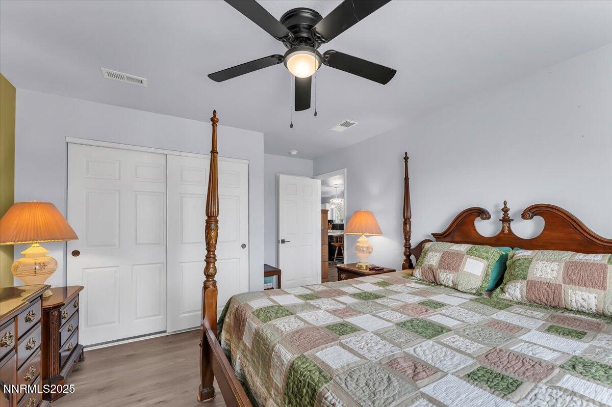 4895 Cheyenne Trail Stagecoach, NV 89429 - Photo 15 of 52 a bedroom with a bed and a chandelier