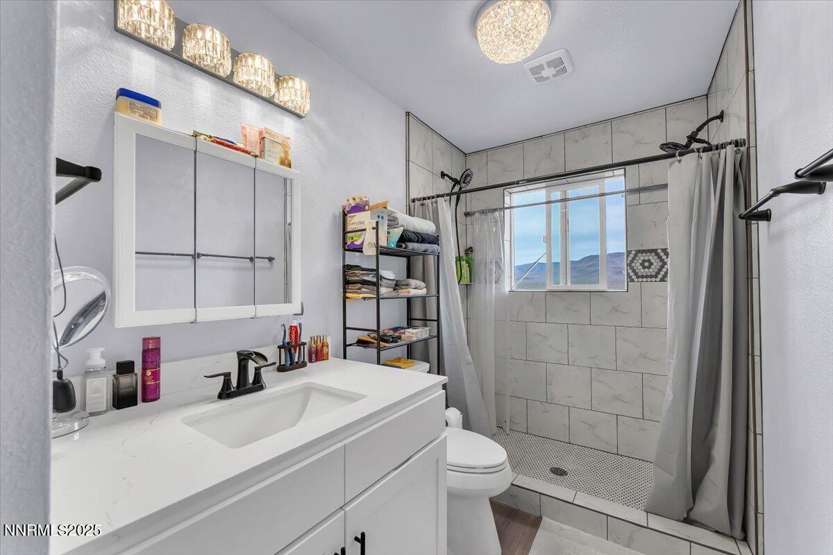 4895 Cheyenne Trail Stagecoach, NV 89429 - Photo 16 of 52 a bathroom with a sink toilet and shower