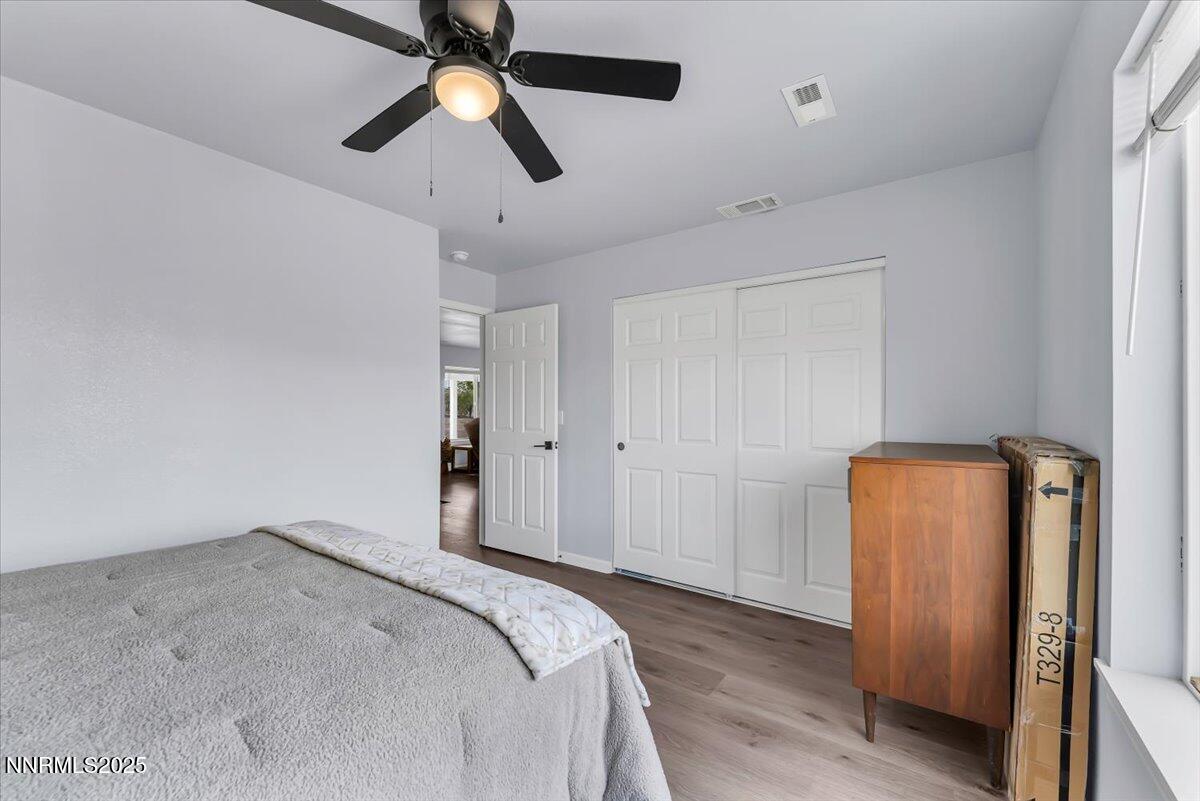 4895 Cheyenne Trail Stagecoach, NV 89429 - Photo 18 of 52 a bedroom with bed and wooden floor