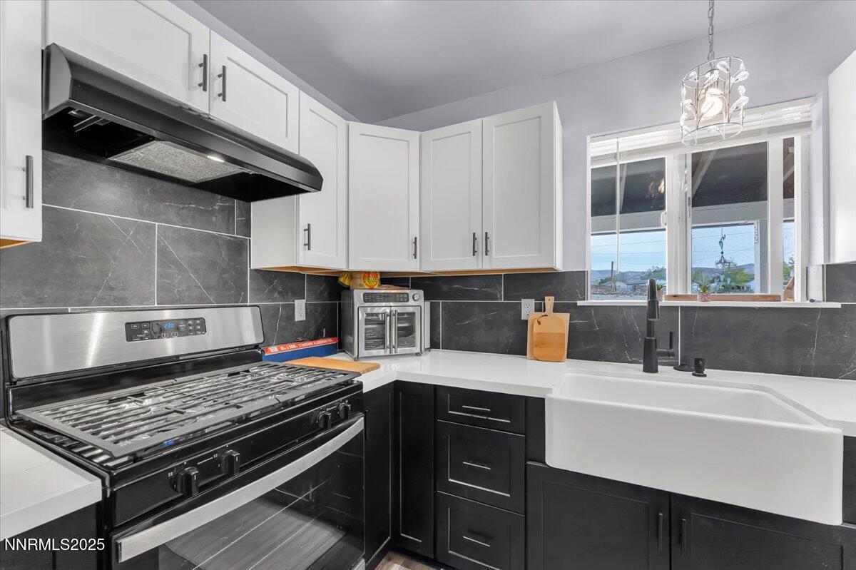 4895 Cheyenne Trail Stagecoach, NV 89429 - Photo 3 of 52 a kitchen with stainless steel appliances granite countertop a stove a sink and a microwave