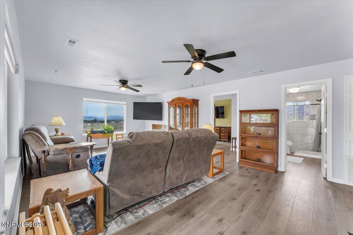 4895 Cheyenne Trail Stagecoach, NV 89429 - Photo 5 of 52 a living room with furniture a ceiling fan and a wooden floor
