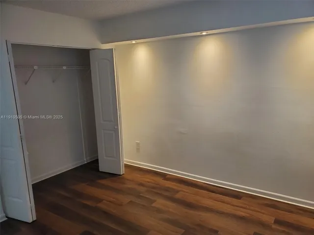 a view of room with wooden floor