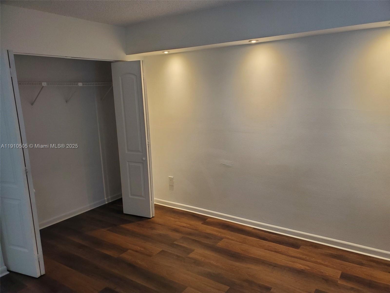 8260 Southwest 210th Street, Unit 217 Cutler Bay, FL 33189 - Photo 12 of 19 a view of room with wooden floor