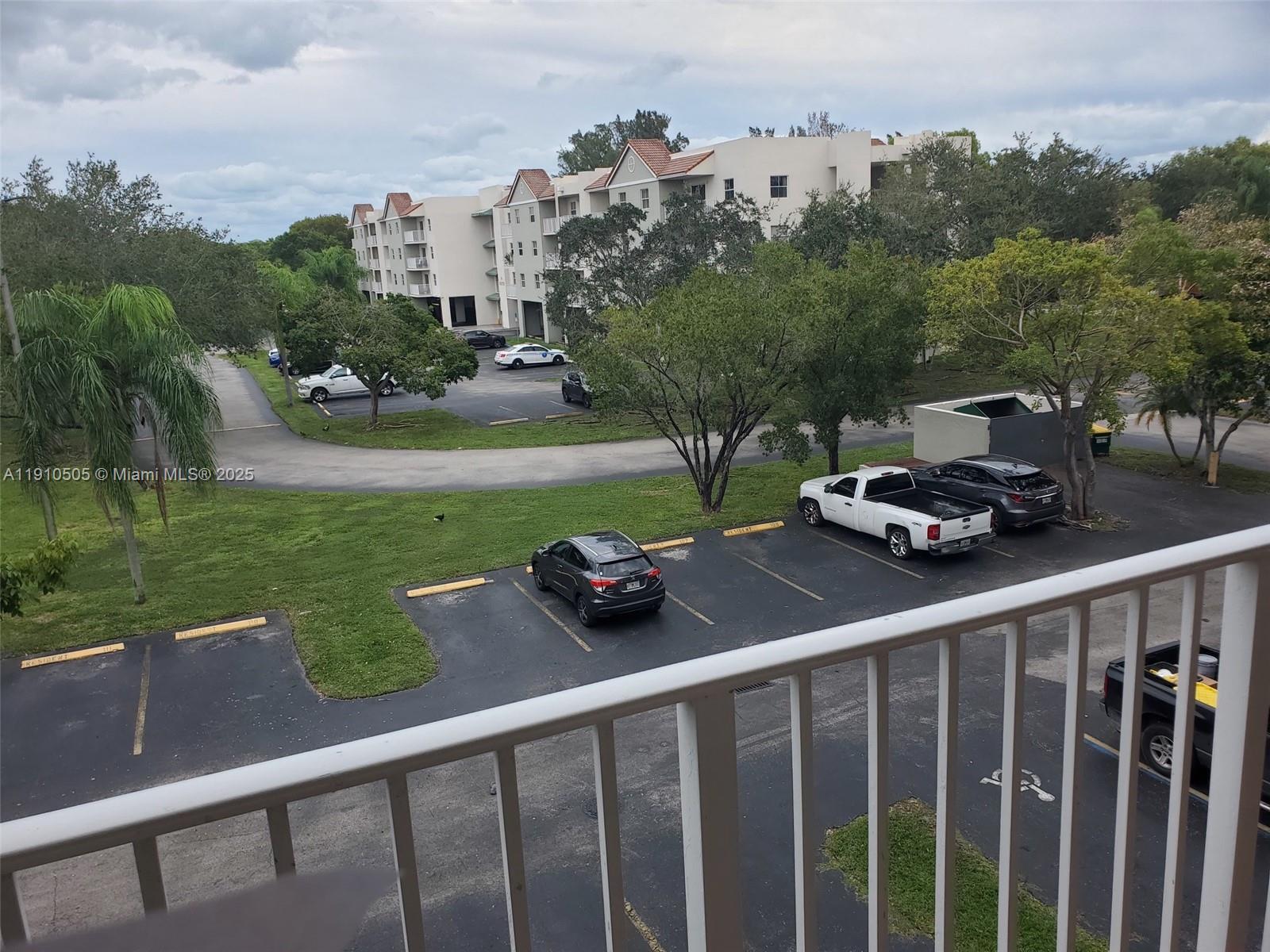 8260 Southwest 210th Street, Unit 217 Cutler Bay, FL 33189 - Photo 15 of 19 a view of a yard with a car parked