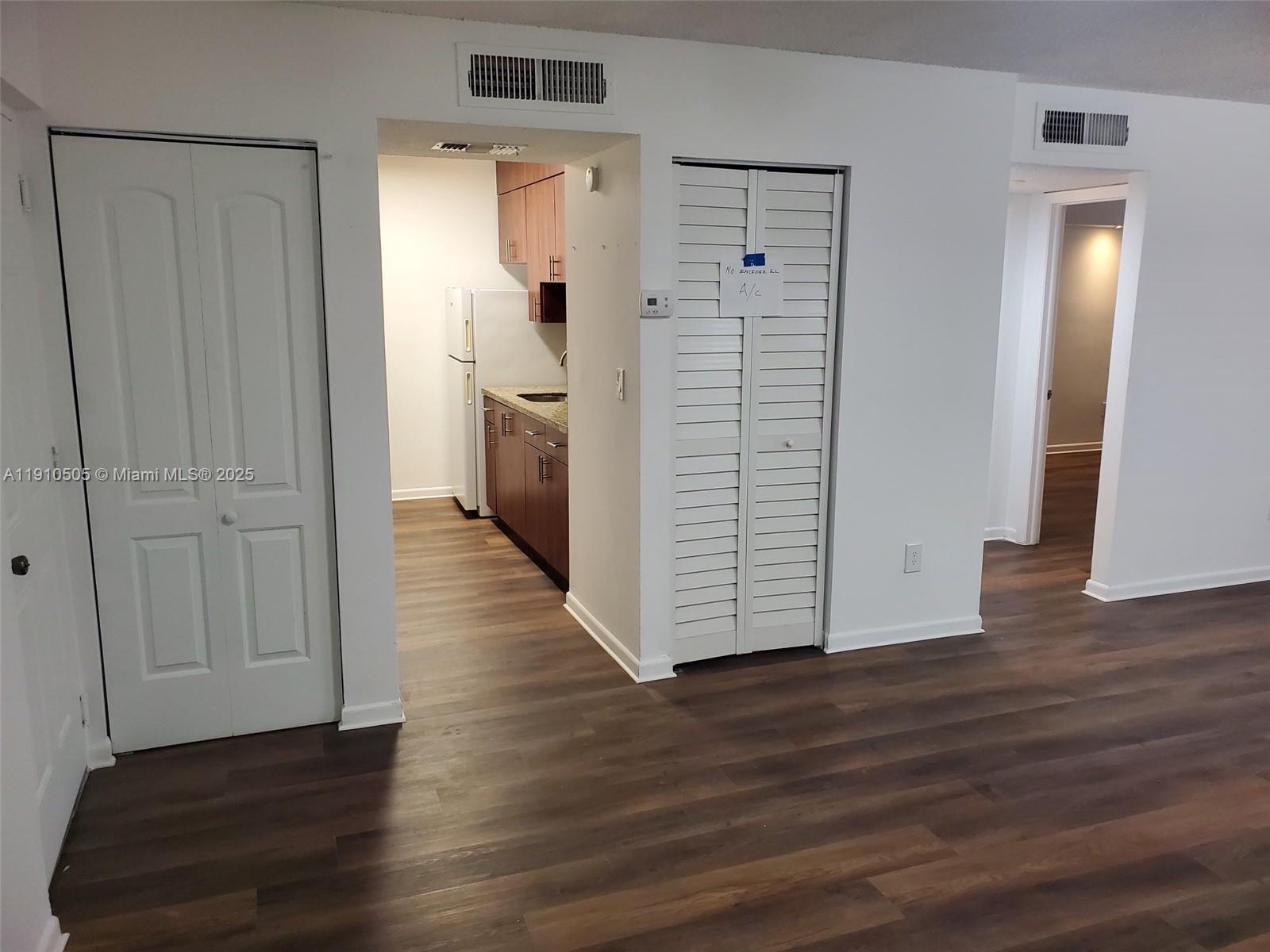 8260 Southwest 210th Street, Unit 217 Cutler Bay, FL 33189 - Photo 4 of 19 a view of a hallway with wooden floor and closet