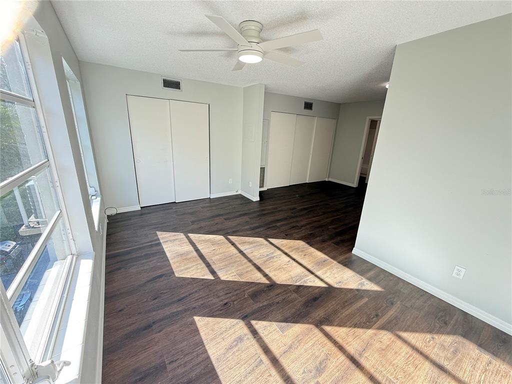 2391 Sumatran Way, Unit 63 Clearwater, FL 33763 - Photo 12 of 15 a view of an empty room and wooden floor
