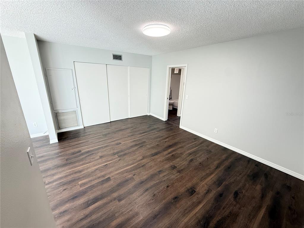 2391 Sumatran Way, Unit 63 Clearwater, FL 33763 - Photo 13 of 15 a view of an empty room with wooden floor