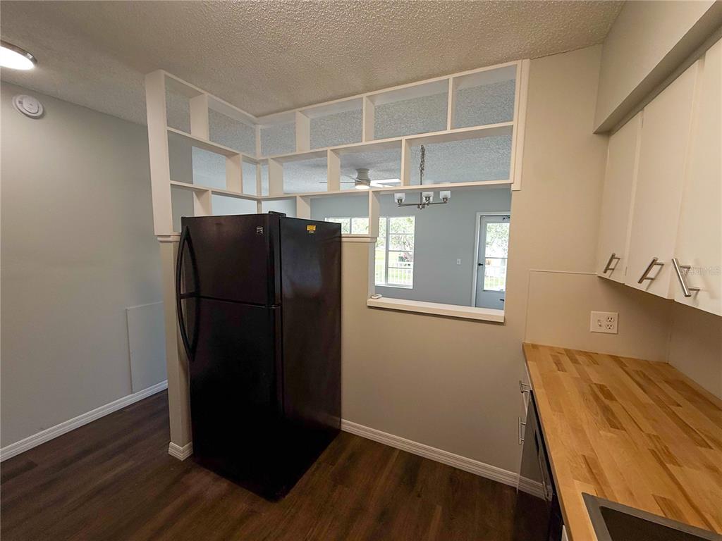 2391 Sumatran Way, Unit 63 Clearwater, FL 33763 - Photo 5 of 15 a view of a refrigerator in kitchen and wooden floor