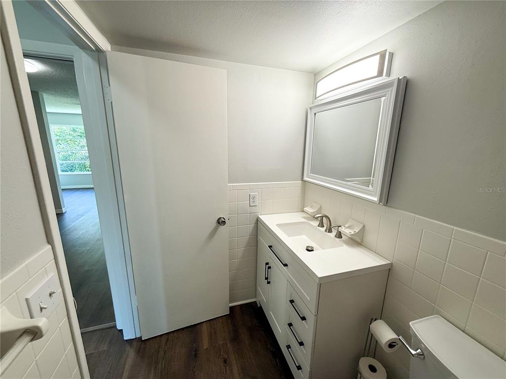 2391 Sumatran Way, Unit 63 Clearwater, FL 33763 - Photo 9 of 15 a bathroom with a sink toilet and mirror
